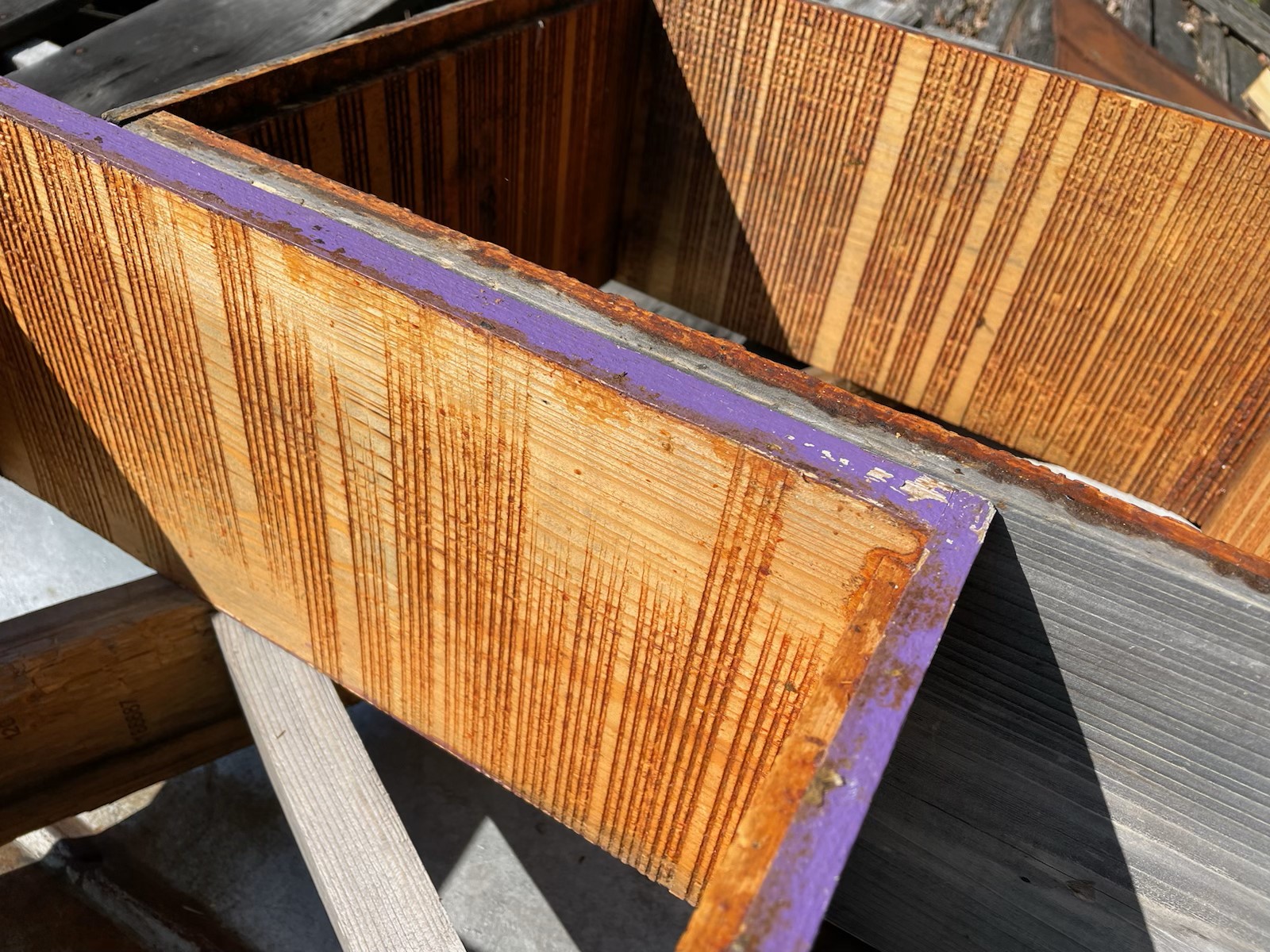 Figure 9: My friend Jake Barker cuts grooves into his hive bodies to encourage propolis deposition. As with my method, you can see where Jake’s saw missed cutting grooves, so the bees did not deposit propolis in those locations. Photo Credit: Jake Barker, used with permission.