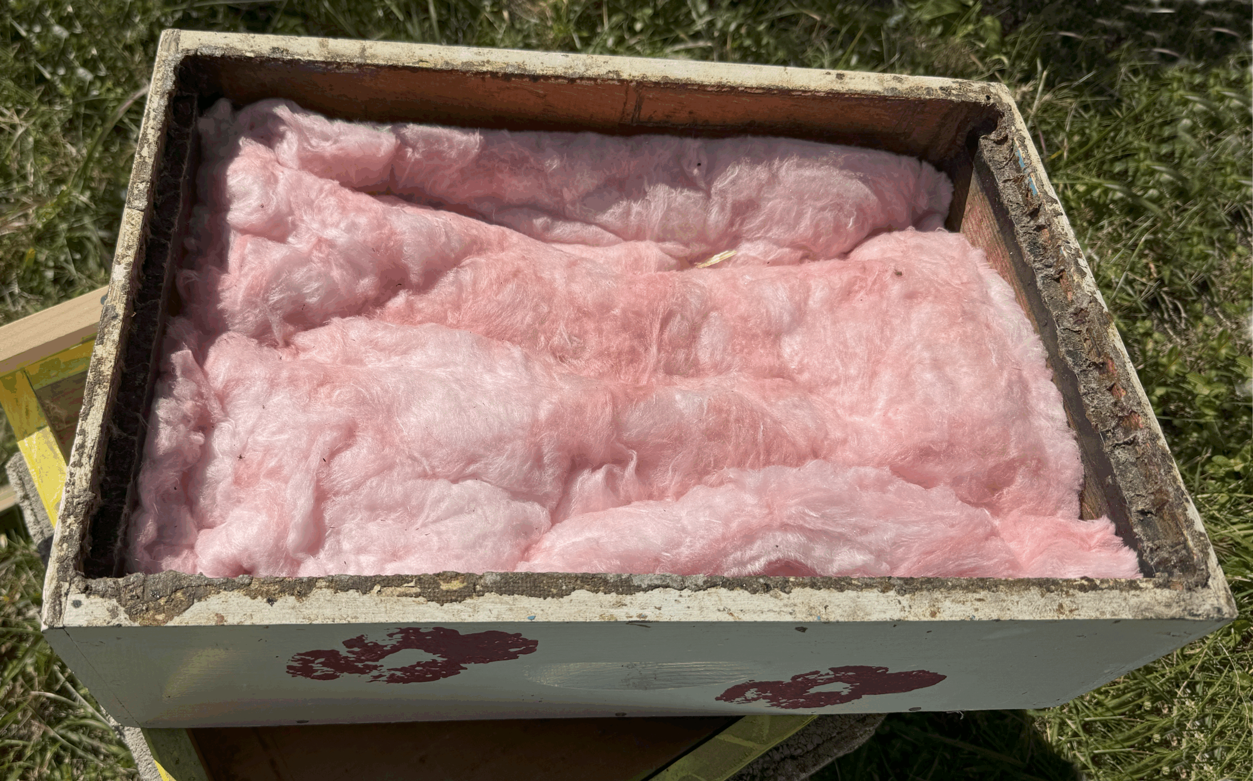 Figure 5. I block the hole in the inner cover, then add a medium box above it filled with two layers of R-19 fiberglass insulation. Photo Credit: Theresa Martin