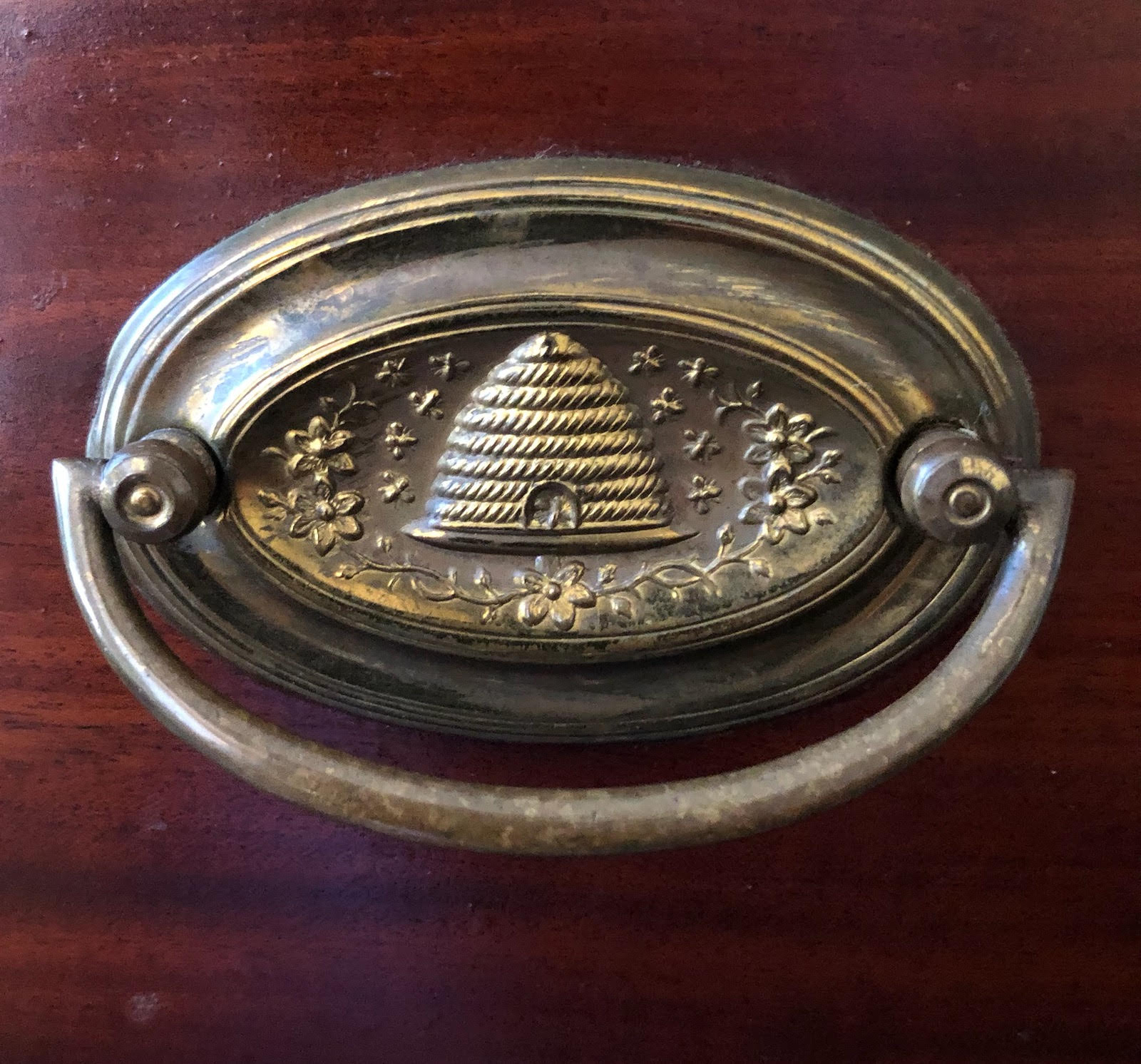 “While there is no evidence that Emily Dickinson ever kept bees, she certainly would have observed them in the family gardens and orchard. In addition, the beautiful ornate image of a bee skep that decorated the drawer handles of this Dickinson family bureau could have been part of the household when Emily Dickinson lived there and if so, would have either consciously, or perhaps subconsciously, helped to keep the thought of bees on the poet’s mind. Photo courtesy of Burleigh Muten, Emily Dickinson Museum”